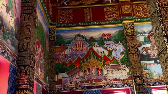 Sacred Buddhist frescoes depicting Jataka tales and Buddha's path to enlightenment at Wat Maha That Wachiramongkol. Spiritual mural art representing Dharma and Thai religious cosmology in Krabi.