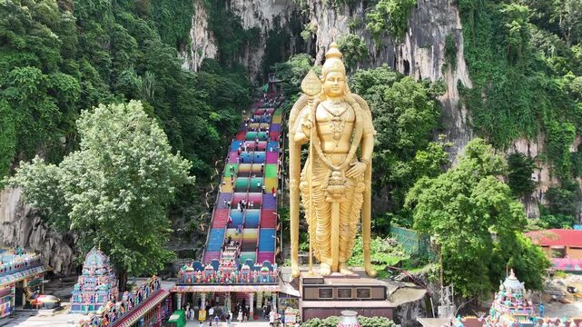 Batu Caves - indian temple with colorful stairs near Kuala Lumpur, Malaysia. Lord Murugan golden statue.