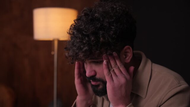 Stressed overwhelmed man suffering from headache and eye strain