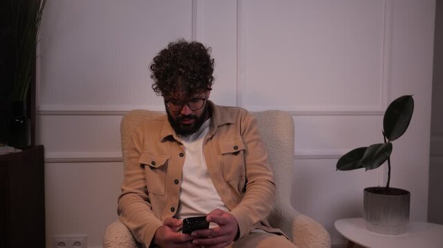 Stressed young man reacting to bad news on his smartphone