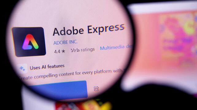 Closeup view of adobe express app on a computer screen with magnifying glass