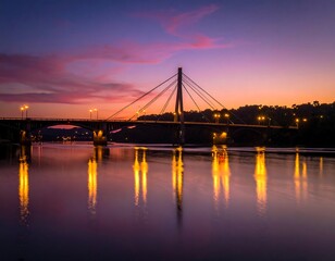 Fototapeta premium A bridge spans a river at dusk, sky ablaze with vibrant hues