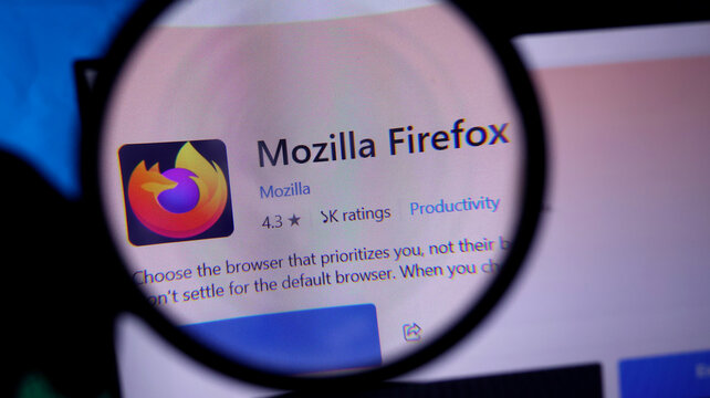Magnifying glass showing mozilla firefox browser on a computer screen closeup