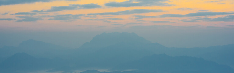 Obraz premium sunrise with moving of cloud and clear sky and layer of mountain