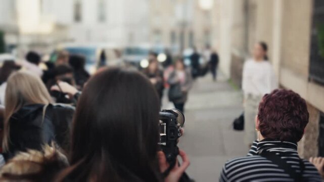 Photographers taking pictures at a fashion week street style event