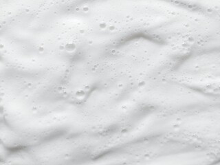 Abstract white soap foam texture with light fluffy bubbles background. Fresh shampoo lather foam backdrop for hygiene concept. © Firman