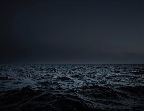 a dark, restless ocean with rolling waves under a glowing full moon casting shimmering light on the water