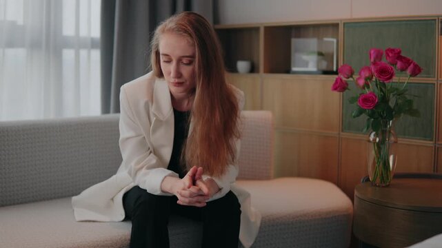 Upset young businesswoman sitting on sofa, disagree rejection unhappy female portrait, feeling lonely and heartbroken after a painful breakup, struggling with anxiety, sadness, emotional exhaustion