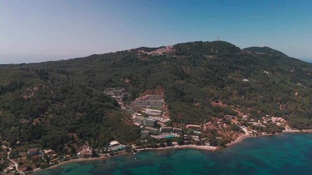 Aerial Drone Flight from Coast Rising up Mountain Slopes to Chlomos Village in Corfu