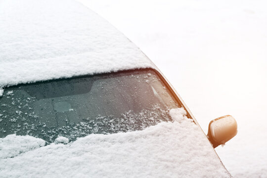 Severe ice covering car windshield after snowstorm