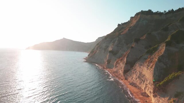 Sunset Aerial Flyaway of Golden Cape Asprokavos Cliffs and Ionian Sea in Corfu
