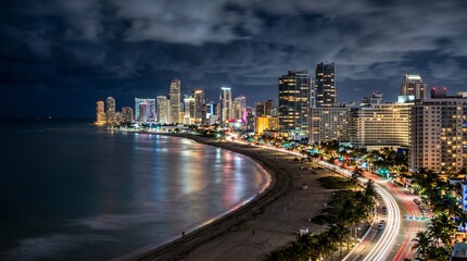 Obraz premium Panama City Skyline at Night with Coastal Highway and Ocean View.