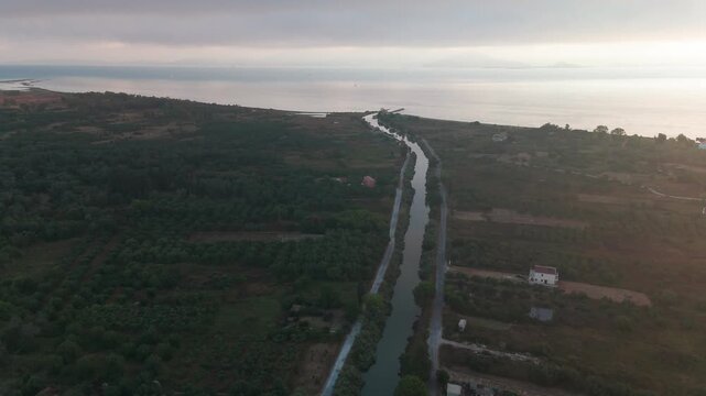 Aerial Tracking Shot of Potami Lefkimmis Canal Flowing into Ionian Sea near Bouka Beach Corfu