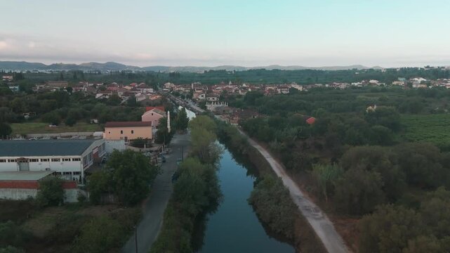 Aerial Bird's Eye View Flying Back Over Potami Lefkimmis Canal Towards Bridge in Corfu Greece