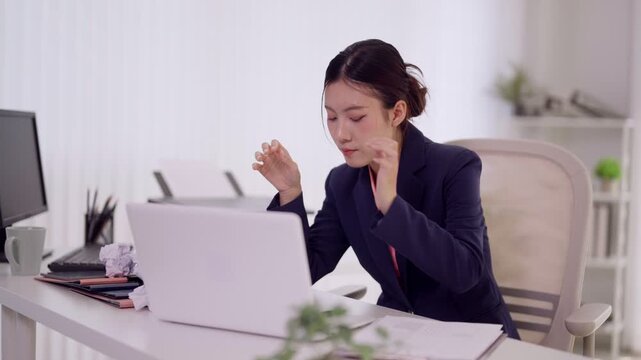 Asian businesswoman excited celebrating success achievement victory reading laptop good news email message winning online working professional office desk