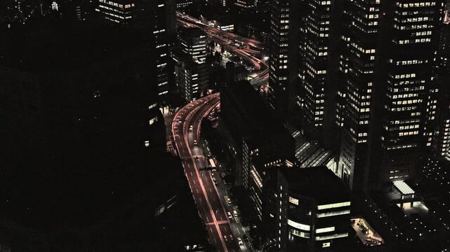 Night in Tokyo : Overlooking the City, The Metropolitan Expressway Winds through Densely Packed Skyscrapers with a Warm Glow  |  Shuto Expressway, Shinjuku, Tokyo, Japan