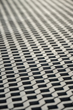 Abstract close up of perforated paving stones creating repeating pattern and depth effect.