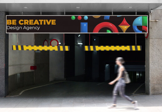A parking entrance mockup in Madrid features a sleek design with barrier arms and a blank advertising space