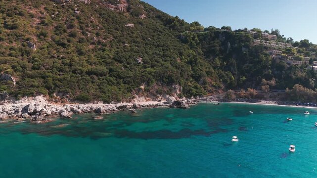 Cinematic Drone View Descending Over Rocky Shoreline and Turquoise Waters at Ermones