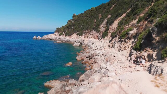 Drone Tracking Shot Over Rugged Coastal Cliffs Heading to Deep Blue Ionian Sea in Corfu Greece