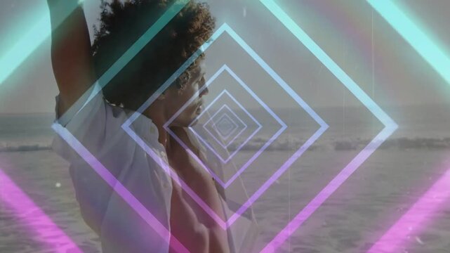Man raising arm and stretching arms on beach, neon diamonds scaling over torso, forming fashion ad