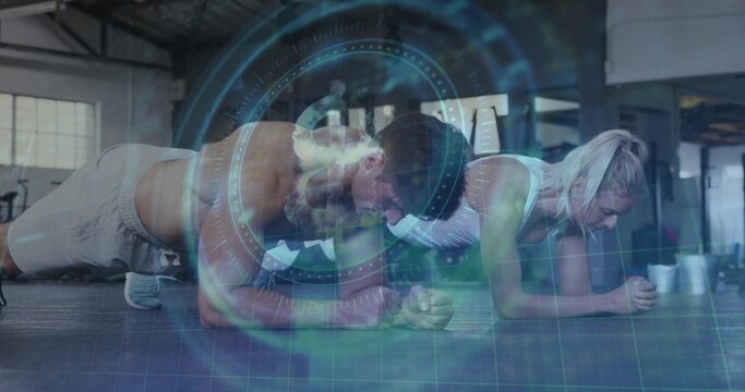 Holding forearm planks, shirtless man and woman in sports bra training in gym with HUD overlay