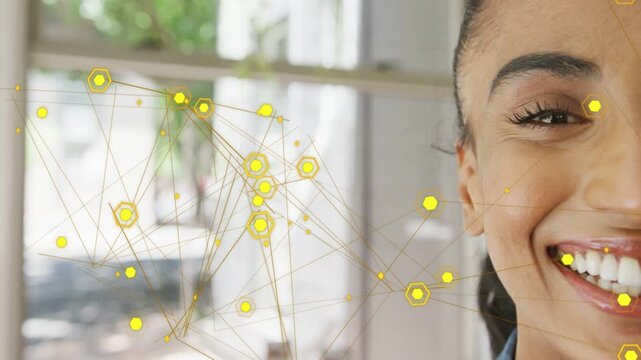 Woman smiling on-camera in tech demo, overlay pulsing, yellow hex nodes shifting, highlighting face