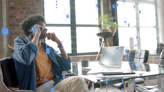 Man answering business call holding phone, leaning back laughing with blue squares overlaying