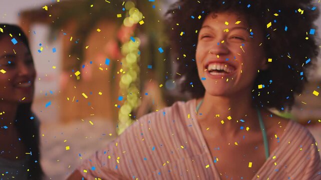 Vertical video: Laughing woman in teal strap leaning on beach as confetti falling, palm lights