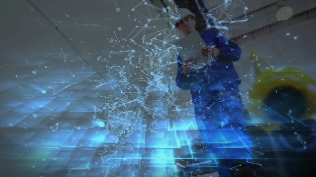 Camera pulling back, male worker gesturing and inspecting overhead gear with industrial AR tracking