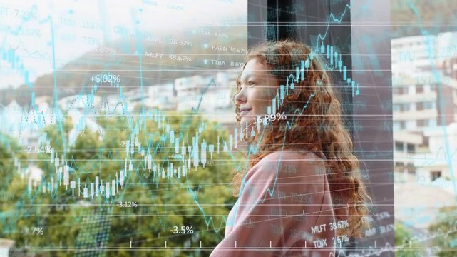 Woman at glass raising hand, motion initiating candlestick charts updating while tracking markets