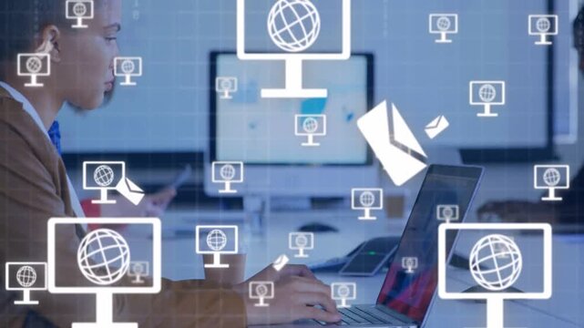 Woman typing laptop at business table activating monitor and envelope icons showing connectivity