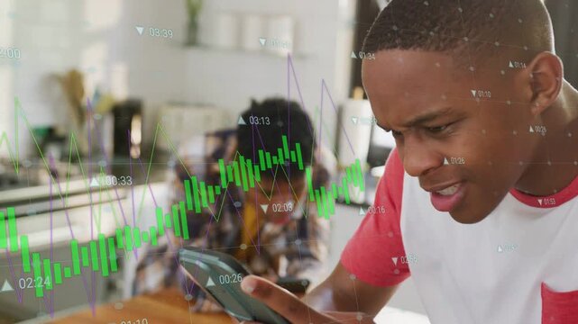 Front teen tapping phone and scrolling animating stock charts to track stocks while peer on phone