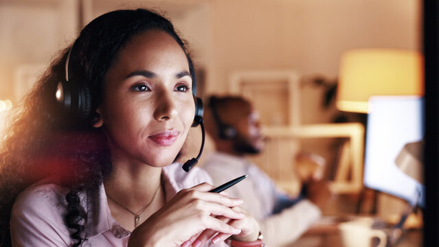 Woman, night and consultant thinking with headset in office for customer service or solution. Thoughtful, female person or agent working late with mic for online advice, virtual assistance or help