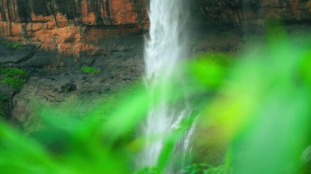 4K Closeup slow motion shot of waterfall hitting the ground during the monsoon season as seen from the forest at Kaataldhar waterfall near Lonavala in Maharashtra, India. Waterfall in monsoon season.