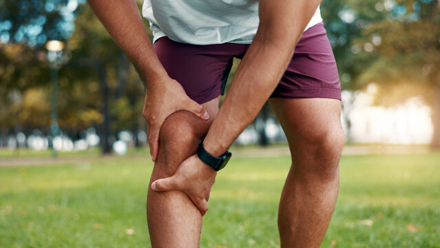 Hands, knee pain and sore at park, fitness and athlete with sprain after exercise or muscle tension. Outdoor, training accident and person with workout injury in nature, inflammation and leg fracture