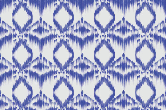 This image features an abstract, repeating pattern in blue on a light background. It resembles traditional textile techniques such as ikat or tie-dye, giving it a handcrafted, artisanal feel. The symm