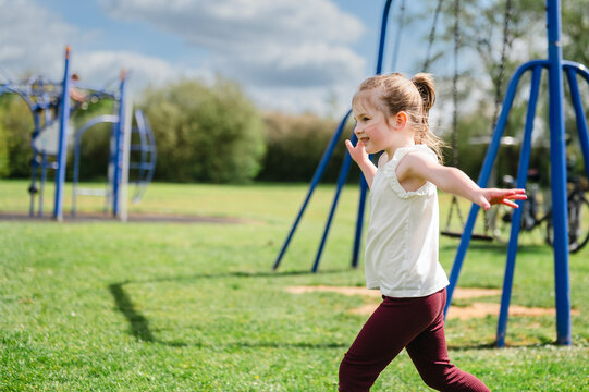 Little girl enjoying outdoor play time at playground