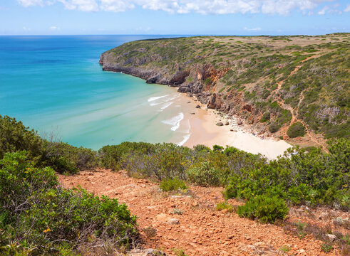A view of a deserted beach with a rocky cliff from the Fisherman's Path (between Sagres and Lagos) in Algarve,  Portugal.