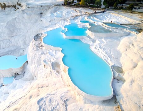 Aerial view of stunning white travertine terraces filled with turquoise water