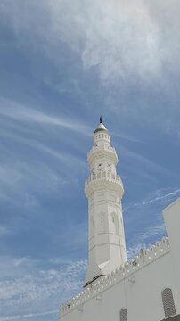 Clear daytime view of Masjid Quba, showcasing its white architecture and peaceful surroundings under a bright blue sky in Medina.