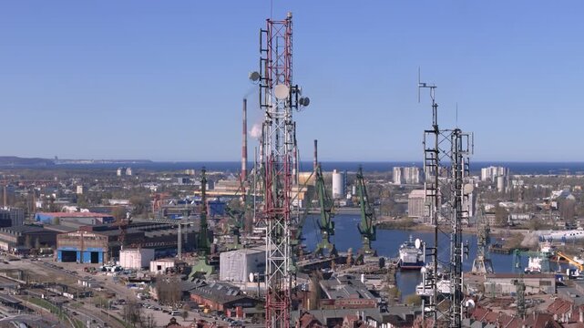 5G telecommunication tower in smart city, digital infrastructure and wireless connectivity concept with urban industrial background, future technology and data network 