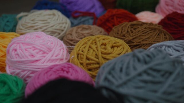 A vibrant assortment of yarn balls in various colors, perfect for crafting, knitting, and DIY projects. Ideal for hobbyists and those looking to add creativity to their handmade items.