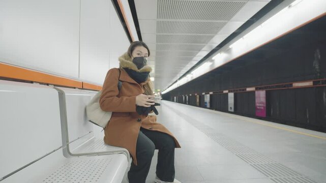 A solitary commuter waits at an urban subway station, highlighting public transport experiences in modern cities. The scene captures the atmosphere of travel and daily routines in a metropolitan setti