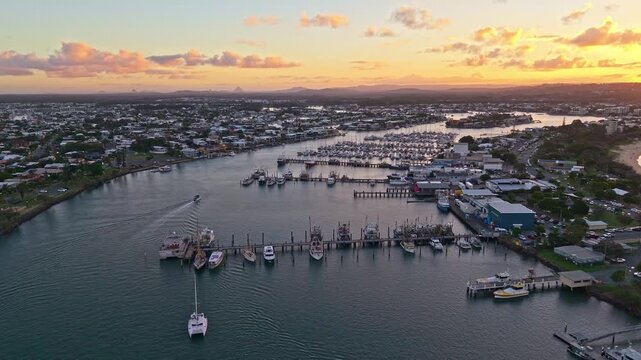Aerial sunset over Mooloolaba Harbour marina and river channels, Sunshine Coast Queensland