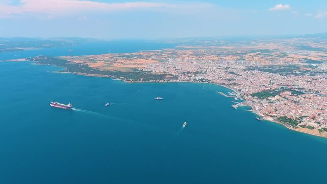 Canakkale, Turkey. Panoramic aerial view of the city on the Asian shore of the Dardanelles Strait, a vibrant Turkish port with ferry terminals and waterfront promenade on a sunny day. Aerial view