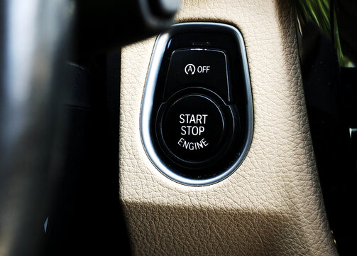 Close-up of a modern car start-stop engine button in a vehicle interior