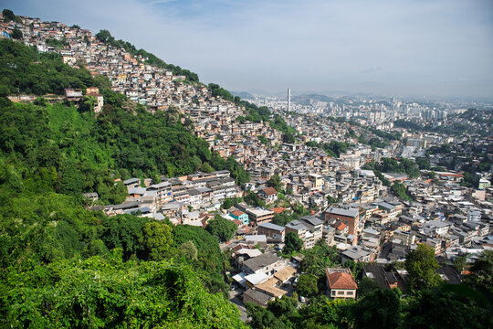 Vibrant cityscape of rio de janeiro displaying dense favela on lush green mountain slope overlooking urban skyline