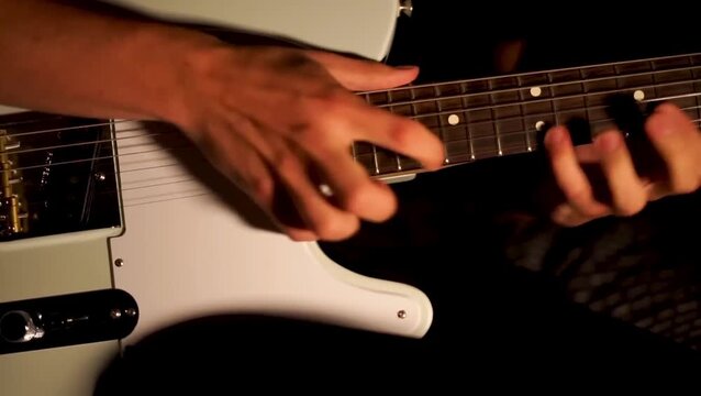 close up man playing guitar