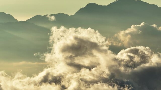 Aerial views of the mountain with clouds. Flying above the clouds